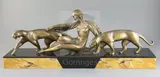 An Art Deco bronze group of a reclining woman with two panthers, on signed two colour marble plinth, 22.75in by Michel Decoux, bronze, sold Dec 2019