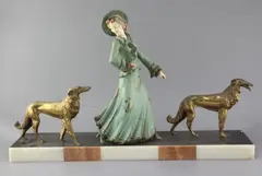 A French Art Deco painted and gilt spelter group of an elegant lady and two borzois, on marble plinth by George Maxim, sculpture, sold Apr 2019