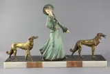 A French Art Deco painted and gilt spelter group of an elegant lady and two borzois, on marble plinth by George Maxim, sculpture, sold Mar 2019