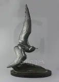 A French Art Deco green patinated bronze model of a seagull flying over a wave by Irénée Rochard, bronze, sold Mar 2019
