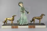 A French Art Deco painted and gilt spelter group of an elegant lady and two borzois, on marble plinth by George Maxim, sculpture, sold Mar 2019