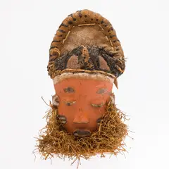 Congo by Pende Mask, carved and painted wood mask with burlap headdress and straw beard, offered Jun 2025
