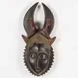 Baule People from Liberia by Lunar Mask, carved and painted wood mask with horned headdress, sold Jun 2025