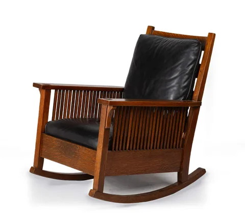 A Flat-Arm Spindle Rocking Chair by Gustav Stickley, circa 1905, Quarter-sawn oak and leather, sold Sep 2026
