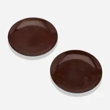 Plates, pair by Eileen Gray, c. 1925, lacquered wood, sold Jun 2022