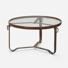Coffee table by Jacques Adnet, c. 1950, saddle-stitched leather over steel, brass, glass, sold Jun 2022