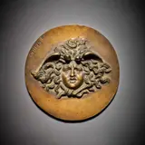 Tête de Méduse by Vincenzo Gemito, Bas-relief en bronze à patine brun clair nuancé, de forme ronde, sold Feb 2026