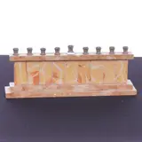 is crafted from polished Jerusalem stone by This modern Hanukkiah, marble, sold Apr 2026