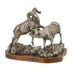 Untitled by Rusty Phelps, bronze depicting two standing rams on w wood plinth. Signed at base. Dimensions: 8, offered Sep 2023