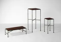 Ensemble de trois sellettes by Olivier Gagnère, 1985, Structure en fer battu à patine bronze, lattes de bois,, sold Oct 2024