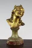 A 19th century gilt bronze bust of a smiling child, on green onyx base by Jean Antoine Injalbert, bronze, offered Dec 2015