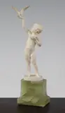 An Art Deco carved ivory figure of a young girl feeding a bird, on a green onyx plinth base by Ferdinand Preiss, sculpture, sold Apr 2015