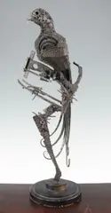 A large textured steel model of a parrot on a perch, with circular stepped base, 25.5in by Walenty Pytel, sculpture, sold Apr 2015