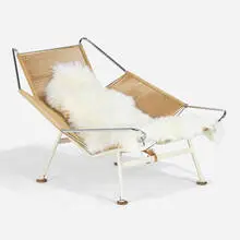 Early Flag Halyard chair by Hans J. Wegner, c. 1950, enameled and matte chrome-plated steel, flagline, wood, sheepskin, sold Apr 2022