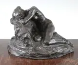 A patinated bronze model of a recumbent female nude, on a rocky base by John Tweed, bronze, sold Feb 2015