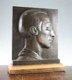 A rectangular bronze portrait plaque depicting a gentleman's head in profile, titled 'Bousouairol Andre by Sylvestre Clerc, bronze, sold Feb 2015