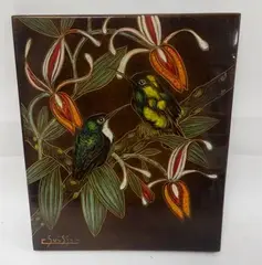 Deux colibris, l'un à gorge blanche, branchés by Gaston Suisse, Panneau rectangulaire en Isorel à décor en laques polychromes, gravé, sur fond brun, sold May 2017