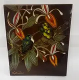 Deux colibris, l'un à gorge blanche, branchés by Gaston Suisse, Panneau rectangulaire en Isorel à décor en laques polychromes, gravé, sur fond brun, sold May 2017