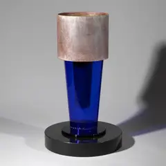 Dreiteiliges Vasenobjekt by Ettore Sottsass, 1994, Metallblech, korrodiert und klar lackiert, blaues Glas und 'Noir de Mazzy' Marmor (Venini, Murano; Gallery Mourmans, Kno, offered Oct 2026