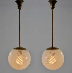Zwei Deckenleuchten 'Reticello' by Carlo Scarpa, um 1940, Messingrohr, Messingblech, Glas, farblos mit weißen Fäden (Venini, Murano), sold Oct 2026