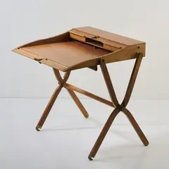 Reiseschreibtisch 'Pippa' by Rena Dumas and Peter Coles, 1991, Birnenholz, Lederbezug, Messingbeschläge (Hermès, Paris), sold Mar 2025
