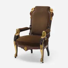 Eyptian Revival armchair by Pottier and Stymus, c. 1875, carved, painted and gilt mahogany, brass, velvet upholstery, sold Nov 2023