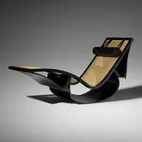 Rio chaise lounge by Oscar and Anna Maria Niemeyer, c. 1978, lacquered wood, caning, leather, sold Oct 2021