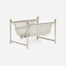 Magazine rack by Maison Jansen, c. 1965, aluminum, brass, sold Sep 2026