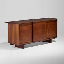 Special-order Triple Sliding Door Radio cabinet by George Nakashima, 1956, American black walnut, oak, cast aluminum, enameled aluminum, sold Sep 2026