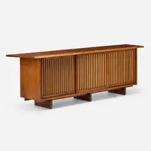 Triple Sliding Door cabinet by George Nakashima, 1972, American black walnut, pandanus cloth, oak, sold Sep 2026