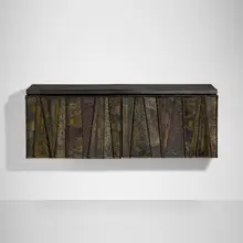 Deep Relief wall-hanging cabinet, model PE 19 by Paul Evans, c. 1970, torch-cut, welded, polychromed and patinated steel, slate, lacquered wood, sold Sep 2026