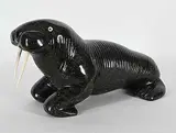 Untitled - Playful Walrus by Nelson Takkiruq, black stone and bone sculpture, sold Sep 2026