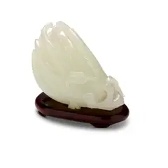 With a fitted wood stand by Qing Dynasty A Fine Chinese White Jade Carved Buddha'S Hand Finger Citron, sold Oct 2026
