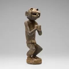 Gbekre monkey figure by Baule, carved wood with encrustation, cloth, sold Oct 2026