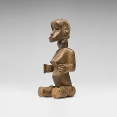 Seated female figure by Dan or Bassa, carved wood, sold Oct 2026