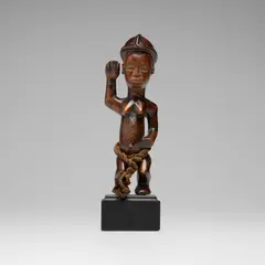 Figure by Cyril Kongo, carved wood, rope, sold Oct 2026