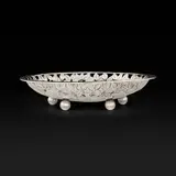 Arts & Crafts table basket by Charles Robert Ashbee, Basket features a repeating reticulated tree motif, the whole forming a blossom. Impressed maker's mark and English hall, sold Oct 2026