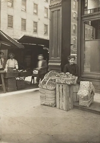 Lewis Hine, Lena Lochiavo - 11 years old, basket (and pretzel) seller, at Sixth Street Market in front of saloon entrance, Cincinnati, Ohio