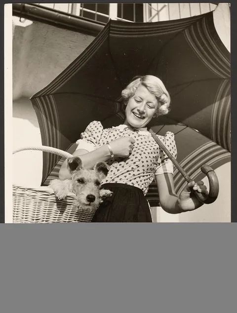 Paul Wolff, [Woman with dog in basket]