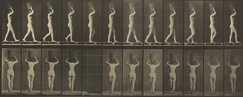 Eadweard Muybridge, Walking and Carrying a 15-lb. Basket on Head, Hands Raised