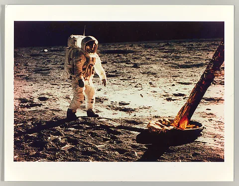 Neil Armstrong, Buzz Aldrin Walking on the Surface of the Moon Near a Leg of the Lunar Module