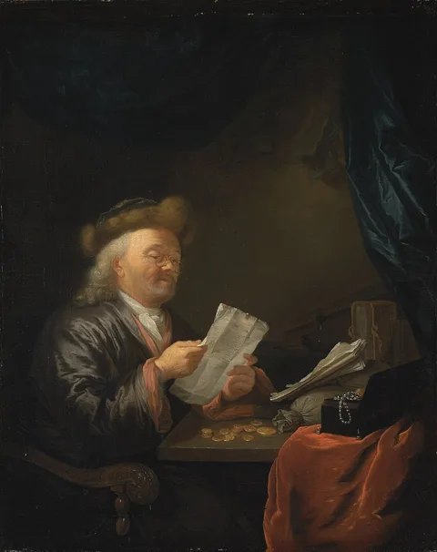 Arnold Boonen, A moneylender reading a letter at a table with coins, books and a jewellery box