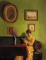 Alfred Broge, Interior with the artist's wife sitting in a sofa, reading.