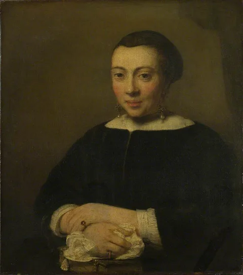 Willem Drost, Portrait of a Young Woman with her Hands Folded on a Book