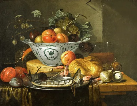 G. van Deynum, Still life of peaches, plums and a bunch of white grapes in a […] bowl resting on a wooden box, a sliced herring in a pewter dish with shrimps and a plum, a bread roll, two onions, a glass and other fruit on a table draped with a green tablecloth