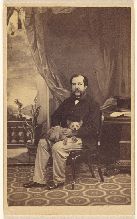 Conway Hart, [Man with Mustache and Muttonchops, seated with a dog on his lap]