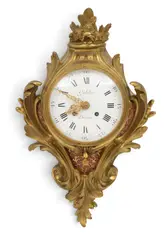 Gübelin, Doré, bronze scrolling acanthus leaf case with floral and leaf finial. Scrolling flora